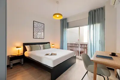 a bedroom with a bed and a table and a desk at Maria Poblenou Apartment by Olala Homes in Barcelona