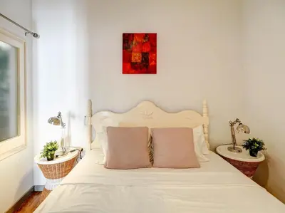 a bedroom with a white bed with two sinks at Espalter White by Hello Homes Sitges in Sitges