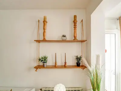 a room with wooden shelves on the wall with potted plants at Espalter White by Hello Homes Sitges in Sitges