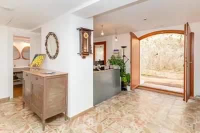 an empty room with a table and a mirror on the wall at El Huerto - Großzügiges Appartment in Katalanischer Masia in Sant Iscle de Vallalta