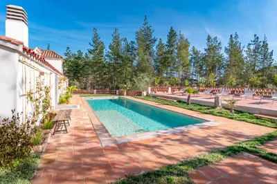 a swimming pool in the backyard of a house at El Huerto - Großzügiges Appartment in Katalanischer Masia in Sant Iscle de Vallalta