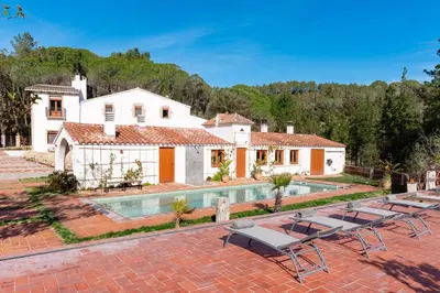 a villa with a swimming pool and a house at Ginkgo - Familienfreundliches Appartment in Katalanischer Masia in Sant Iscle de Vallalta