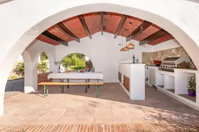 a kitchen with an arched ceiling with a table and a bench at Ginkgo - Familienfreundliches Appartment in Katalanischer Masia in Sant Iscle de Vallalta
