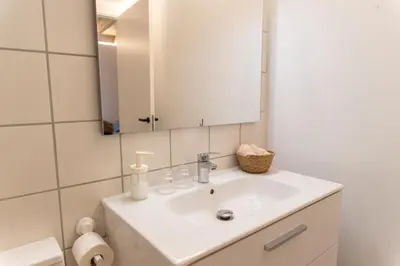 a bathroom with a white sink and a mirror at Cal Teixidor in Mediona