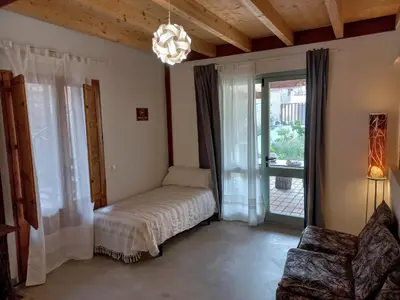 a bedroom with a bed and a large window at Cal Teixidor in Mediona