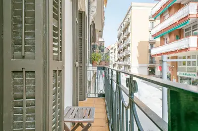 a balcony with a bench on a city street at Alcam Galileu P in Barcelona