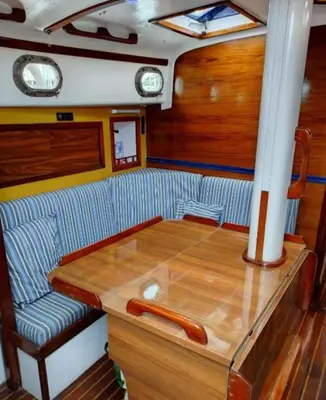 a dining room on a boat with a wooden table at Vintage and cozy sailing boat in Barcelona in Barcelona
