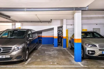 two cars parked in a parking garage at Luxe Forum Beach Terrace in Sant Adria de Besos