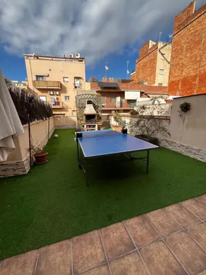 a ping pong table sitting on top of a patio at Precioso apartamento con magnífico patio. in Sant Feliu de Llobregat