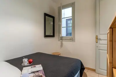 a room with a bed and a window and a table at Canela Homes BARCELONA LESSEPS in Barcelona