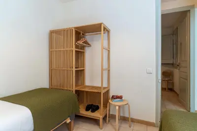 a bedroom with a bed and a book shelf next to a bed at Canela Homes BARCELONA LESSEPS in Barcelona