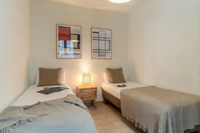 a bedroom with two beds and a lamp on a table at Canela Homes BARCELONA LESSEPS in Barcelona