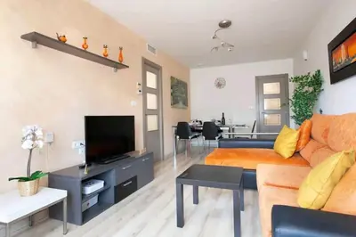 a living room with a couch and a tv at Centric Apartment Gran Via 5 in Hospitalet de Llobregat