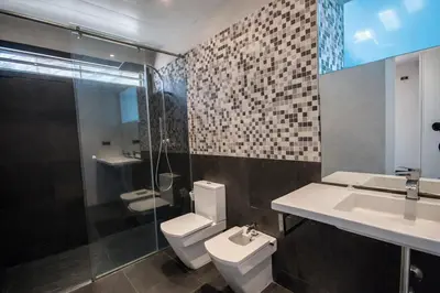 a bathroom with a toilet and a sink and a shower at Catalunya Casas Modern Hilltop Haven with private pool 7km to beach in Castellet