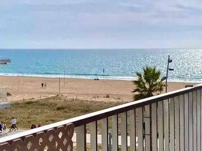 a view of the beach from a balcony of a beach at BEACHFRONT APARTMENT Castelldefels in Castelldefels