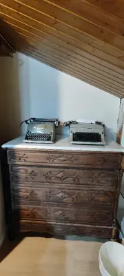 a wooden dresser with two printers on top of it at CAL LLOP in Sant Cugat de Sesgarrigues
