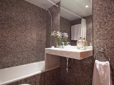 a bathroom with a sink and a bath tub at My Space Emirates - Park Güell Triplex with Private Terrace in Barcelona