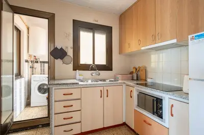 a kitchen with a sink and a refrigerator at Apartamento 3 hab 15 minutos de Barcelona centro y 5 minutos playa in Sant Adria de Besos