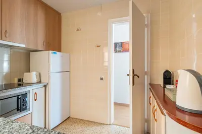 a kitchen with a white refrigerator and a sink at Apartamento 3 hab 15 minutos de Barcelona centro y 5 minutos playa in Sant Adria de Besos