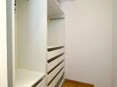a walk in closet with white cabinets at Apartment Raco in Vilanova i la Geltrú