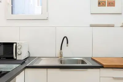 a kitchen with a sink and a microwave at Centric Apartment Molino P3 in Barcelona