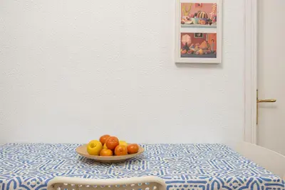 a bowl of fruit on a table with a plate of fruit at Centric Apartment Molino P3 in Barcelona