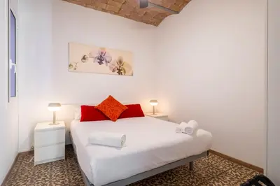 a bedroom with a white bed with red pillows at Centric Molino Theatre 1-1 in Barcelona