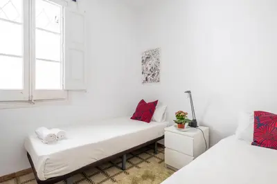 a white room with two beds and a window at Centric Molino Theatre 1-1 in Barcelona