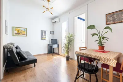 a living room with a table and a chair at Centric Molino Theatre 1-1 in Barcelona