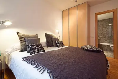 a bedroom with a large bed with pillows on it at My Space Emirates - Charming Duplex in Barcelona ideal for Families or Friends in Barcelona