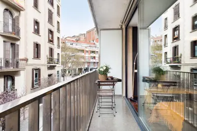 an apartment balcony with a table and stools on it at My Space Emirates - Executive Apartments with Private Balcony in Barcelona
