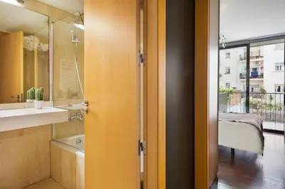 a bathroom with a tub and a sink and a mirror at My Space Emirates - Executive Apartments with Private Balcony in Barcelona