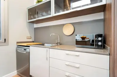 a kitchen with a sink and a microwave at Enamorats Glorias in Barcelona