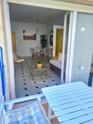 a living room with a couch and a table at Nice beachside 2-BD apt near Barcelona in Cunit