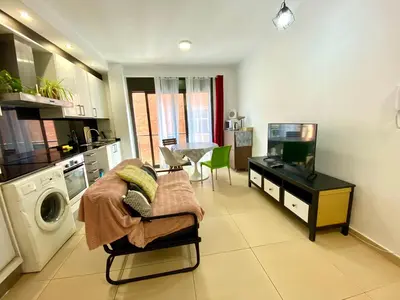 a kitchen with a washer and dryer in a room at Estancias mensuales Terrassa in Terrassa
