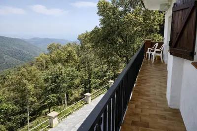 a balcony with a view of the mountains at Catalunya Casas Ultimate tranquility in rural Costa Brava! in Tordera