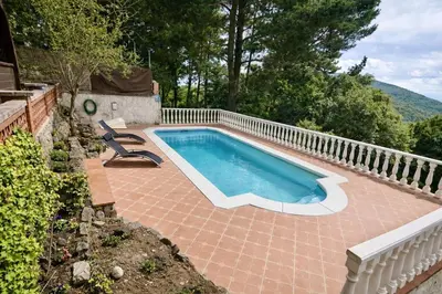 a swimming pool in a backyard with a fence at Catalunya Casas Ultimate tranquility in rural Costa Brava! in Tordera