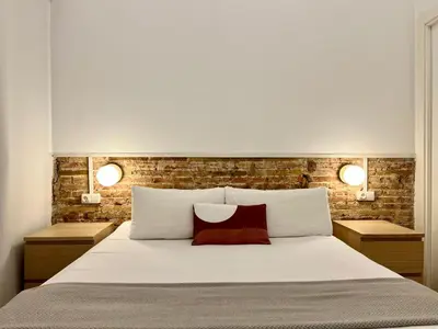 a bedroom with a large bed with two night stands at Stay U-nique Apartments Vila de Gracia II in Barcelona