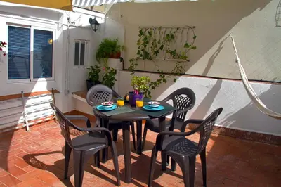 a table and chairs in a patio with a table and chairs at Casa Tortilla Sant Antoni in Barcelona