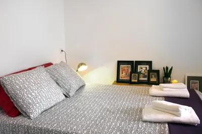 a bedroom with a bed with two towels on it at Casa Tortilla Sant Antoni in Barcelona