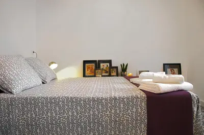 a bedroom with a bed with two towels on it at Casa Tortilla Sant Antoni in Barcelona