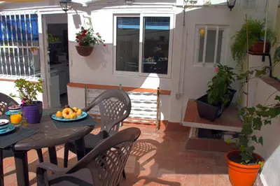 a patio with a table and chairs with fruit on it at Casa Tortilla Sant Antoni in Barcelona