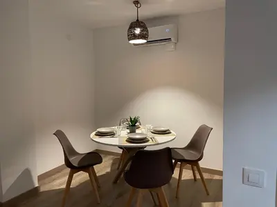 a dining room with a white table and chairs at Barri Vell 4 in Manresa