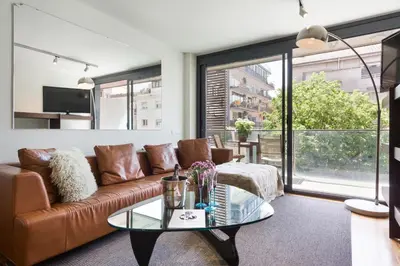 a living room with a couch and a glass table at My Space Emirates - Spacious Apartments near the City Center in Barcelona