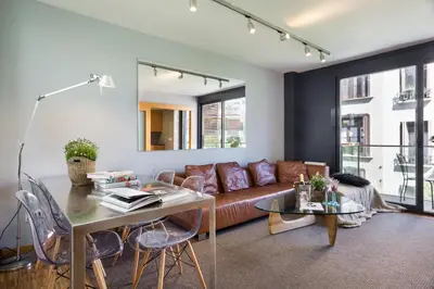 a living room with a couch and a table at My Space Emirates - Spacious Apartments near the City Center in Barcelona