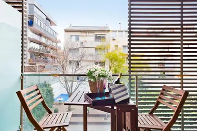 a balcony with a table and two chairs and a window at My Space Emirates - Spacious Apartments near the City Center in Barcelona