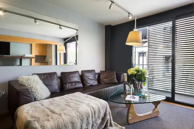 a living room with a couch and a glass table at My Space Emirates - Spacious Apartments near the City Center in Barcelona