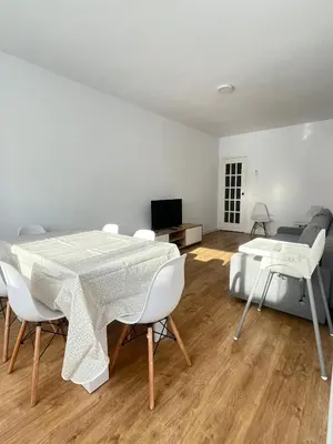 a living room with a table and chairs and a couch at Vilamarlux VIII in Vilassar de Mar