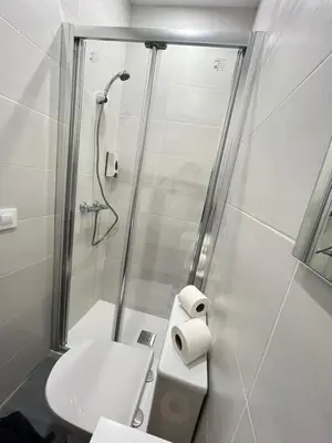 a bathroom with a shower and a toilet and a sink at Vilamarlux VIII in Vilassar de Mar