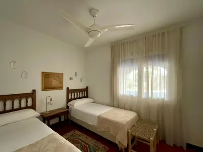 a bedroom with two beds and a window at SITGES Masia Sències in Sitges